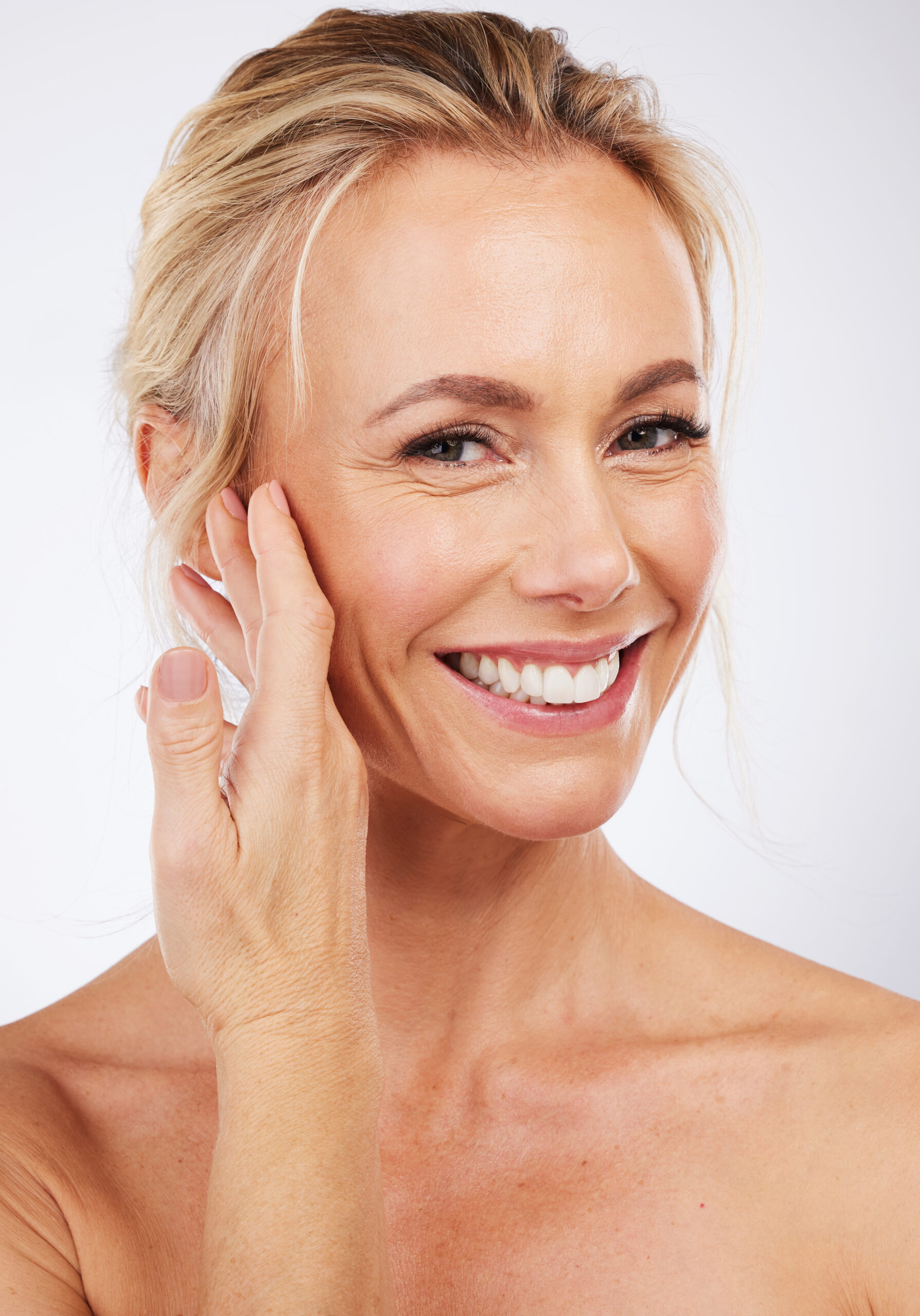 Beauty, hand on face and portrait of woman for skincare, cosmetics and anti aging dermatology. Mature aesthetic model on studio grey background for self love, care and healthy or wellness facial glow